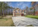 Traditional home with attached garage and long driveway in a verdant setting at 440 Cottonpatch Rd, Lawrenceville, GA 30046