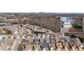 Aerial of neighborhood featuring many single-Gathering homes and natural wooded area at 1555 Diplomat Dr, Cumming, GA 30041