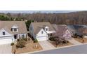 Aerial view of the house showcasing its location in a neighborhood, with a tree in the front yard at 1555 Diplomat Dr, Cumming, GA 30041