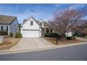 A beautiful home with a well-kept lawn and an attached two-car garage at 1555 Diplomat Dr, Cumming, GA 30041