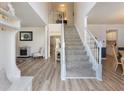 Inviting entryway with a staircase, coat rack, and stylish decor, leading to the living areas at 6455 N Glen Dr, Cumming, GA 30028