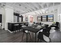 Modern dining area with black table and white chairs next to a kitchen island and stainless steel appliances at 878 Peachtree Ne St # 711, Atlanta, GA 30309