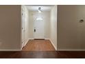 View of the entryway featuring hardwood floors, white trim, and a modern lighting fixture at 950 Spring Ives Dr, Lawrenceville, GA 30043