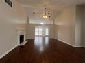 Spacious living room with hardwood floors, a fireplace, and vaulted ceilings at 950 Spring Ives Dr, Lawrenceville, GA 30043