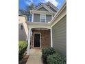 Inviting front entrance with stone accents, covered porch, and manicured shrubs at 108 Creekwood Trl, Acworth, GA 30102