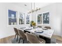 Inviting dining room featuring hardwood floors, large windows, and a contemporary light fixture at 1247 Bridges Sw Ave # A, Atlanta, GA 30310