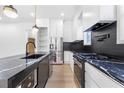 Chef's kitchen featuring black marble waterfall island and stainless steel appliances at 1247 Bridges Sw Ave # A, Atlanta, GA 30310