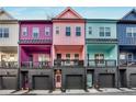 A row of modern townhouses with vibrant colors and garage parking in a residential neighborhood at 160 Color Cir, Atlanta, GA 30317
