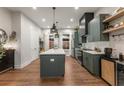 Modern kitchen featuring an island, pendant lighting, stainless appliances, and sleek cabinetry at 160 Color Cir, Atlanta, GA 30317