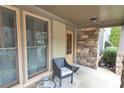 Cozy front porch featuring stone accents, an outdoor chair, and a view of the greenery enhancing the curb appeal at 3919 Teal Cir, Powder Springs, GA 30127