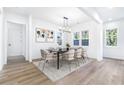 Bright dining room with contemporary lighting, a table for six, and large windows at 1247 Bridges Sw Ave # B, Atlanta, GA 30310