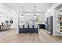 Modern kitchen features a large island, stainless steel appliances, and pendant lighting at 1247 Bridges Sw Ave # B, Atlanta, GA 30310