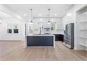 Open kitchen with a large island, modern appliances, and plenty of natural light from the windows at 1247 Bridges Sw Ave # B, Atlanta, GA 30310