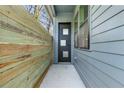 Side entrance featuring a modern door with glass panels and a view of the home's exterior at 1247 Bridges Sw Ave # B, Atlanta, GA 30310