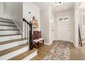Inviting foyer with wood floors, a stylish bench, and a staircase leading to the upper level at 1677 Foresta Ct, Atlanta, GA 30341