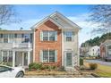 Charming brick and siding townhome with a well-manicured front yard and a welcoming entrance at 4645 Valais Ct # 135, Alpharetta, GA 30022