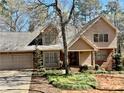 Charming two-story home with a brick and tan siding exterior and well-manicured front yard at 4811 West Lake Se Dr, Conyers, GA 30094