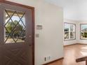 Inviting entryway featuring a decorative glass door and a view into a well-lit living space with hardwood floors at 5595 Wylmoor, Norcross, GA 30093