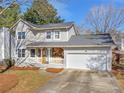 Charming home featuring stone accents and a front porch, with a paved driveway leading to a two-car garage at 5595 Wylmoor, Norcross, GA 30093