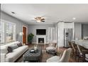 Open-concept living room with fireplace, stainless steel appliances, and bar seating at , Atlanta, GA 30315
