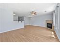 Spacious living room featuring hardwood floors, a fireplace, and lots of light at 695 Georgetown Ct, Jonesboro, GA 30236