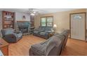 Cozy living room with a stone fireplace, hardwood floors, and comfortable seating at 2643 Rocky Creek Rd, Hampton, GA 30228