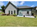 Relaxing backyard features a patio with seating, a bench, and well-kept lawn, ideal for outdoor enjoyment at 310 Ellington Dr, Canton, GA 30115