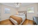 Bright bedroom with hardwood floors, a ceiling fan, and ample natural light from two windows at 3334 Spring Meadow Ct, Tucker, GA 30084