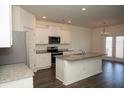 Bright, open kitchen featuring stainless appliances and a large center island at 443 Faulkner St, Stockbridge, GA 30281