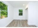 A sunny room featuring new flooring, fresh paint, and multiple windows for natural light at 451 Collier Ridge Dr, Atlanta, GA 30318