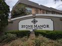 Elegant Stone Manor community sign in Sandy Springs, with lush landscaping and architectural details at 6980 Roswell Rd # E11, Atlanta, GA 30328