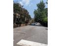 Community parking lot with multiple parking spots, surrounded by trees and foliage at 6980 Roswell Rd # E11, Atlanta, GA 30328