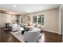 Sun-drenched living room with hardwood floors, neutral decor, and an open layout to the dining area at 2600 Cohassett Ct, Decatur, GA 30034