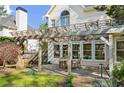 Outdoor patio area featuring a pergola, ceiling fans, and a table with chairs for entertaining at 2996 Bea Mar Dr, Marietta, GA 30062