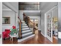 Grand two-story foyer with hardwood floors, staircase and views into the living spaces at 310 Persimmon Dr, Sharpsburg, GA 30277