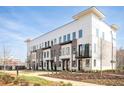 Modern townhome with black window trim, front yards, and contemporary architecture at 7220 Summit Pl, Alpharetta, GA 30009