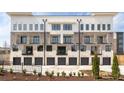 Back of townhome with garages, modern architecture, black framed windows, and individual balconies at 7220 Summit Pl, Alpharetta, GA 30009