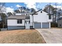 Beautifully renovated home with a fresh white exterior, gray accents, and a spacious two-car garage at 2562 Tritt Springs Ne Trce, Marietta, GA 30062