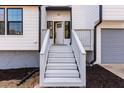 Welcoming front entrance with white stairs, fresh landscaping, and a partially opened front door at 2562 Tritt Springs Ne Trce, Marietta, GA 30062