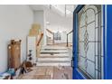 Bright entryway featuring tiled flooring, a staircase, and a decorative glass front door at 2724 Long Lake Ne Dr, Roswell, GA 30075