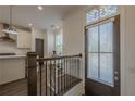 Inviting entryway with hardwood floors and a view of the modern kitchen beyond at 4565 Sims Park Overlook, Suwanee, GA 30024