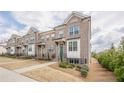 Charming row of two-story brick townhomes with well-maintained lawns and inviting curb appeal at 4565 Sims Park Overlook, Suwanee, GA 30024
