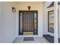 An inviting front door that is newly painted featuring sidelights and a brick facade at 667 Oaktree Park Ct, Lawrenceville, GA 30044