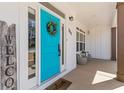 Inviting front porch featuring a cheerful blue door and cozy seating area at 111 Franklin Rd, Woodstock, GA 30188