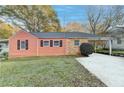 Charming home featuring vinyl siding, brick accents, and a covered carport with a freshly paved driveway at 5164-0 Phillips Dr, Forest Park, GA 30297