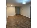 Spacious living room features modern lighting, neutral color palette, and wood-look floors at 1076 Grant Se Way, Atlanta, GA 30315