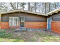Street view of a home with brick accents, updated windows, and a well-manicured lawn at 3007 Pasadena Dr, Decatur, GA 30032