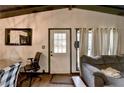 Bright living room features a white door, a gray sofa, light-colored walls, and a modern, minimalistic design at 3007 Pasadena Dr, Decatur, GA 30032