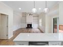Open-concept living room with fireplace, built-ins, hardwood floors, and slider to deck at 3061 Stone Bridge Sw Trl, Conyers, GA 30094