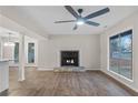 Cozy living room featuring a fireplace, large windows, and ceiling fan at 6382 Revena Dr, Morrow, GA 30260